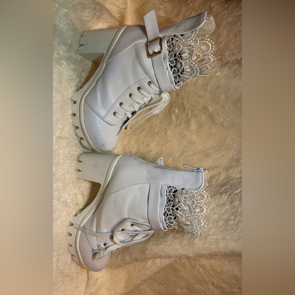 White platform shoes, size women’s 6.5, has lace at top and belt across